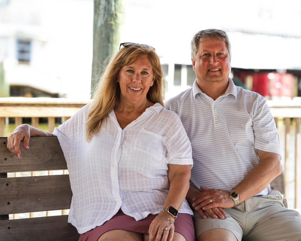 Renee and Jose Malachowski seated on a waterfront dock in Southwest Florida